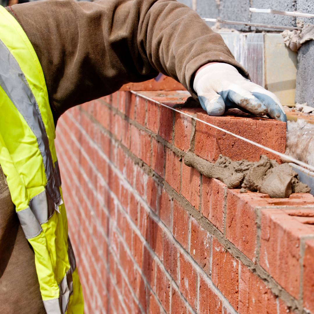 Builder laying bricks