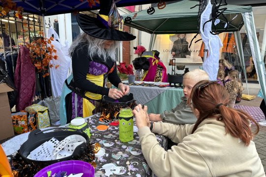 Person bartering with a market stall owner