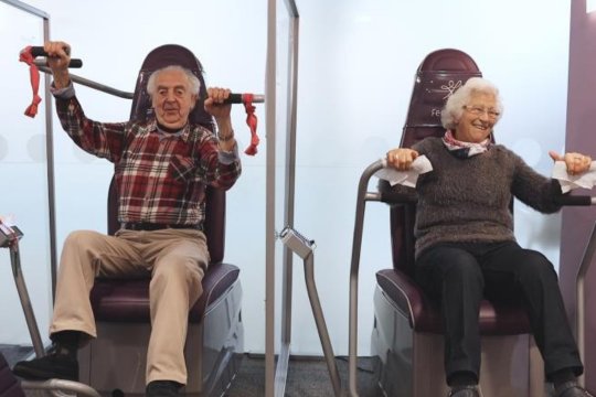 Elderly couple on having fun on exercise equipment