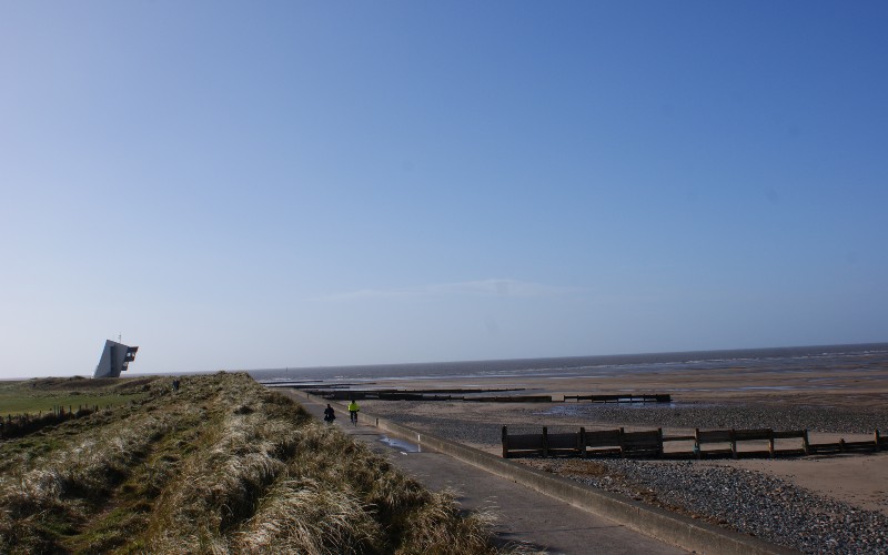 View taking in grass, path, sand, and sea in Fleetwood.