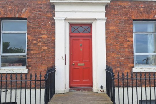 Large red door of a red brick building