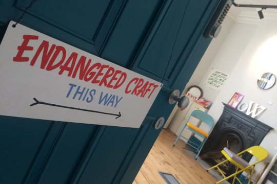 Sign in Fleetwood Market House studios that says &#039;Endangered Craft This Way&#039;