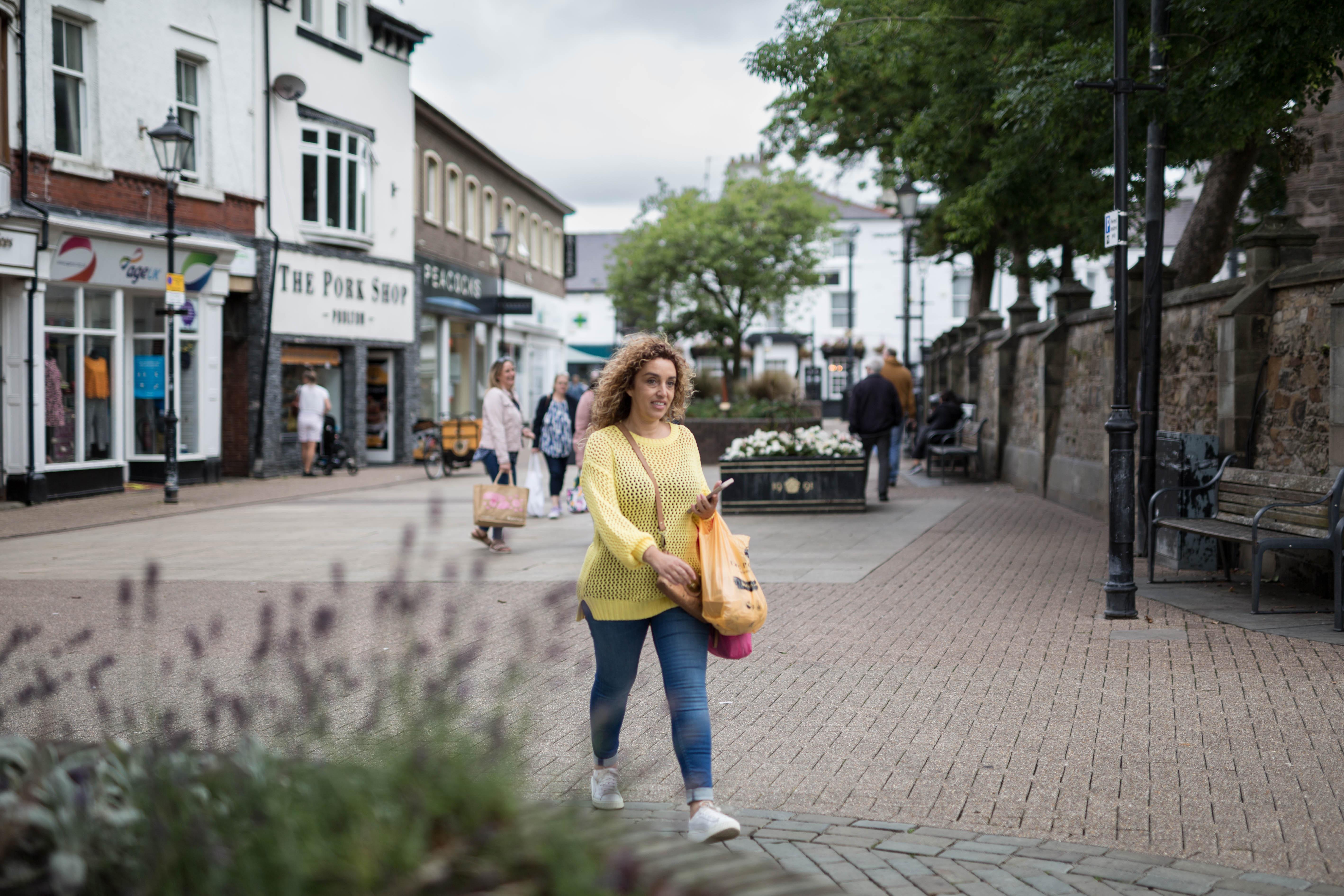 a young shopper in Poulton market square carrying a handbag