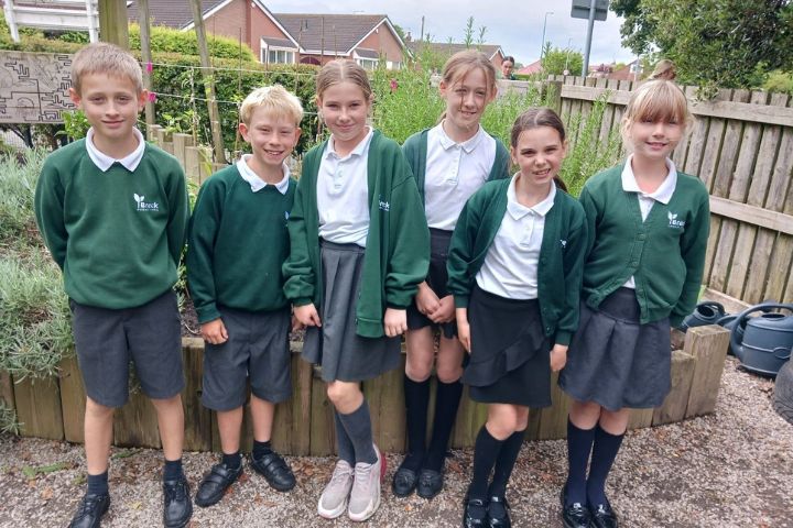 Children posing in a garden for Wyre in Bloom 2024