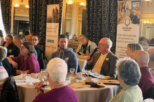 Group of people sitting at a round table at an event