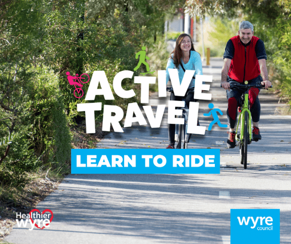 Active Travel - Learn to ride. Two smiling people riding their bike on a wide path towards the camera,